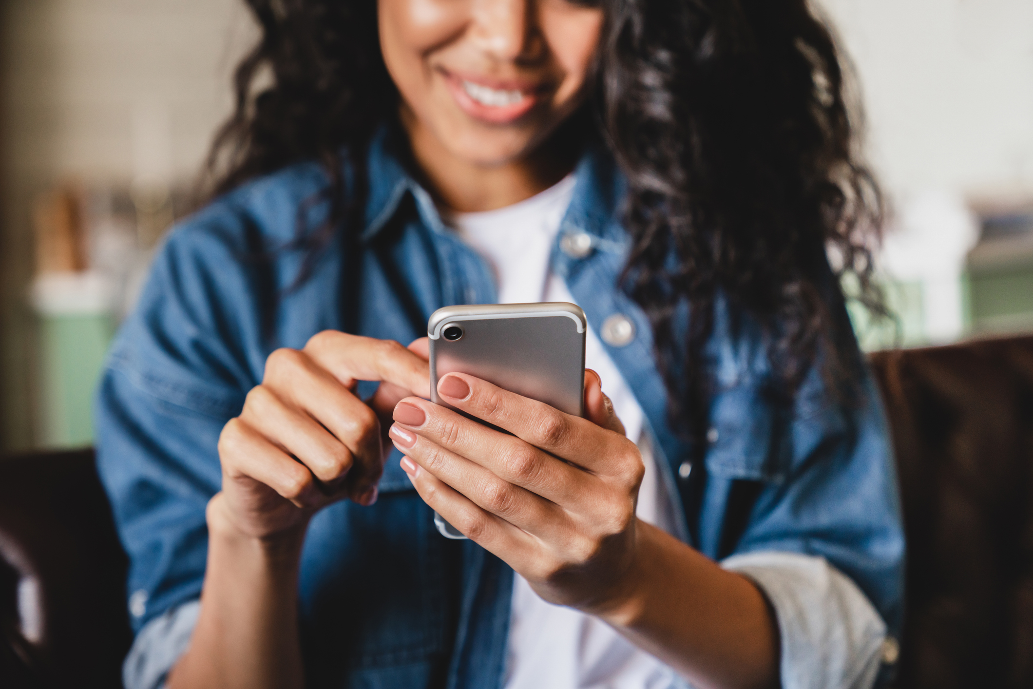 Young woman using smartphone with a smile.