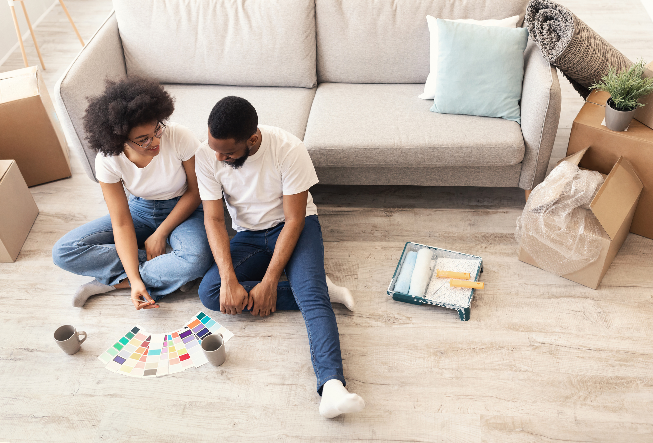 Two children playing a board game on the floor in a cozy living room.
